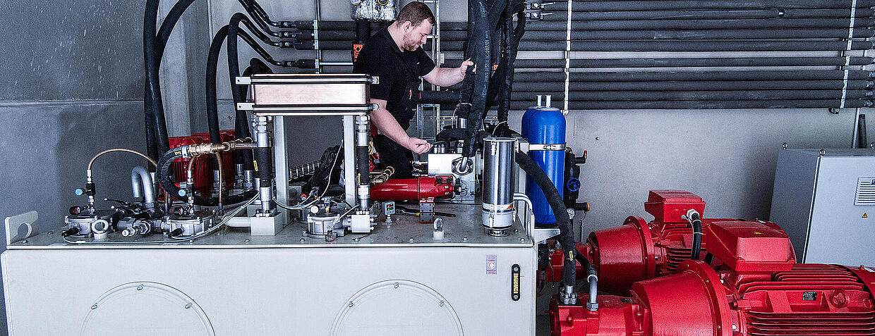 [Translate to Germany - German:] Mitarbeiter checkt Maschine
